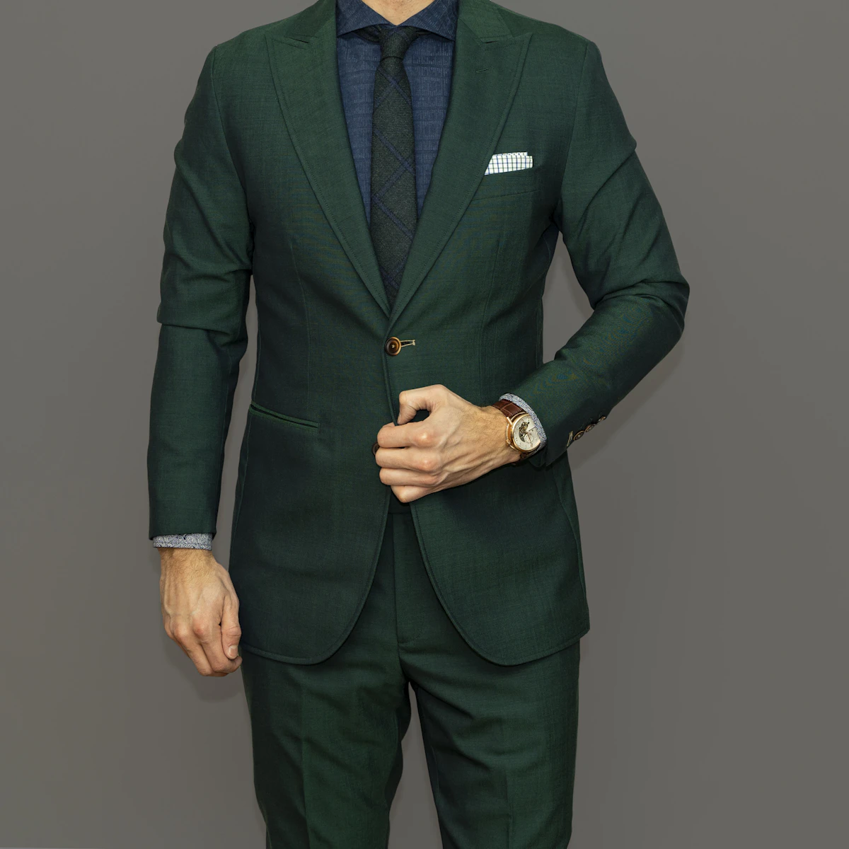 A bespoke two-piece suit in charcoal wool, precisely tailored